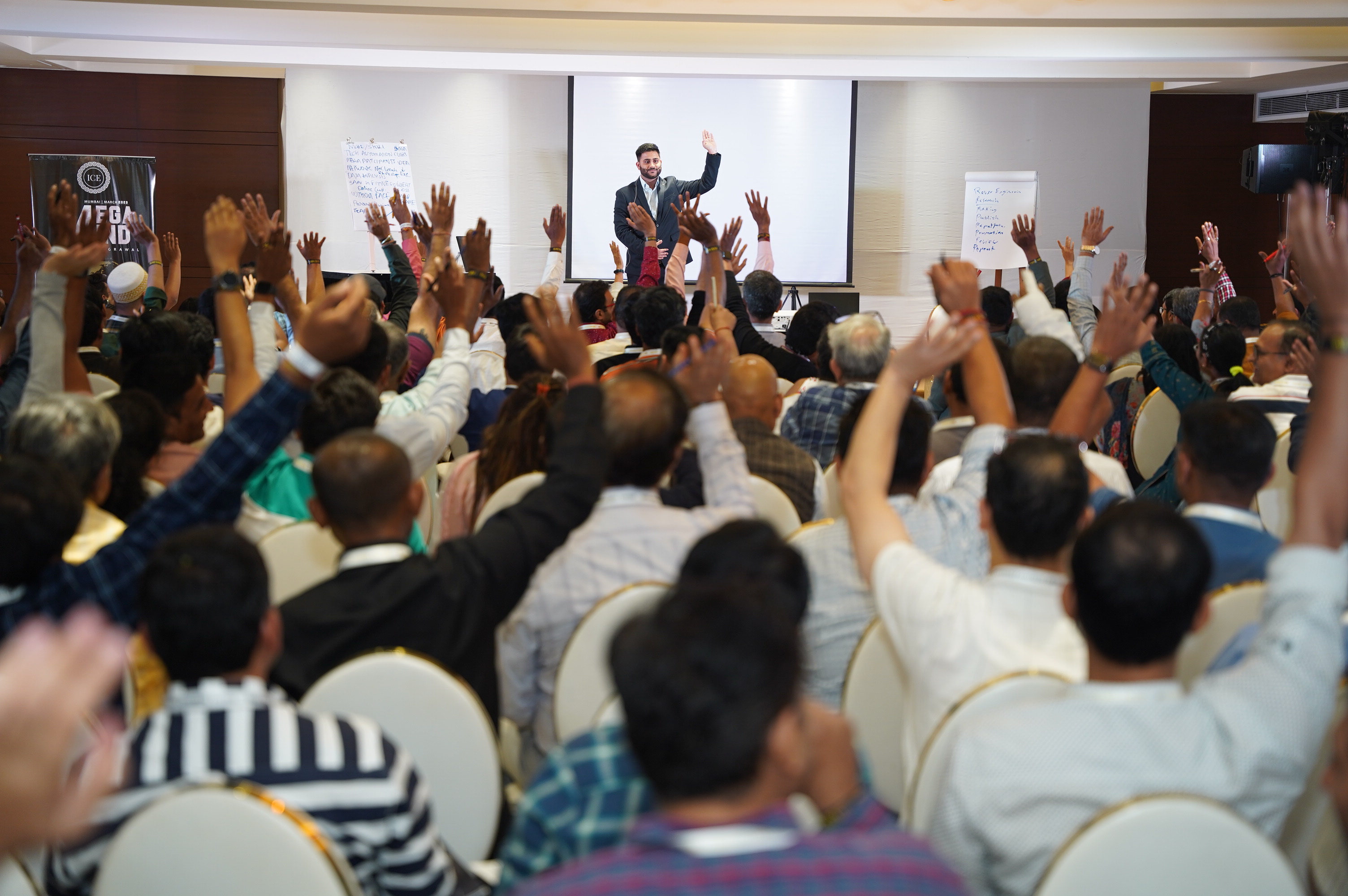 Audience raising hands at Navin Parmar's workshop